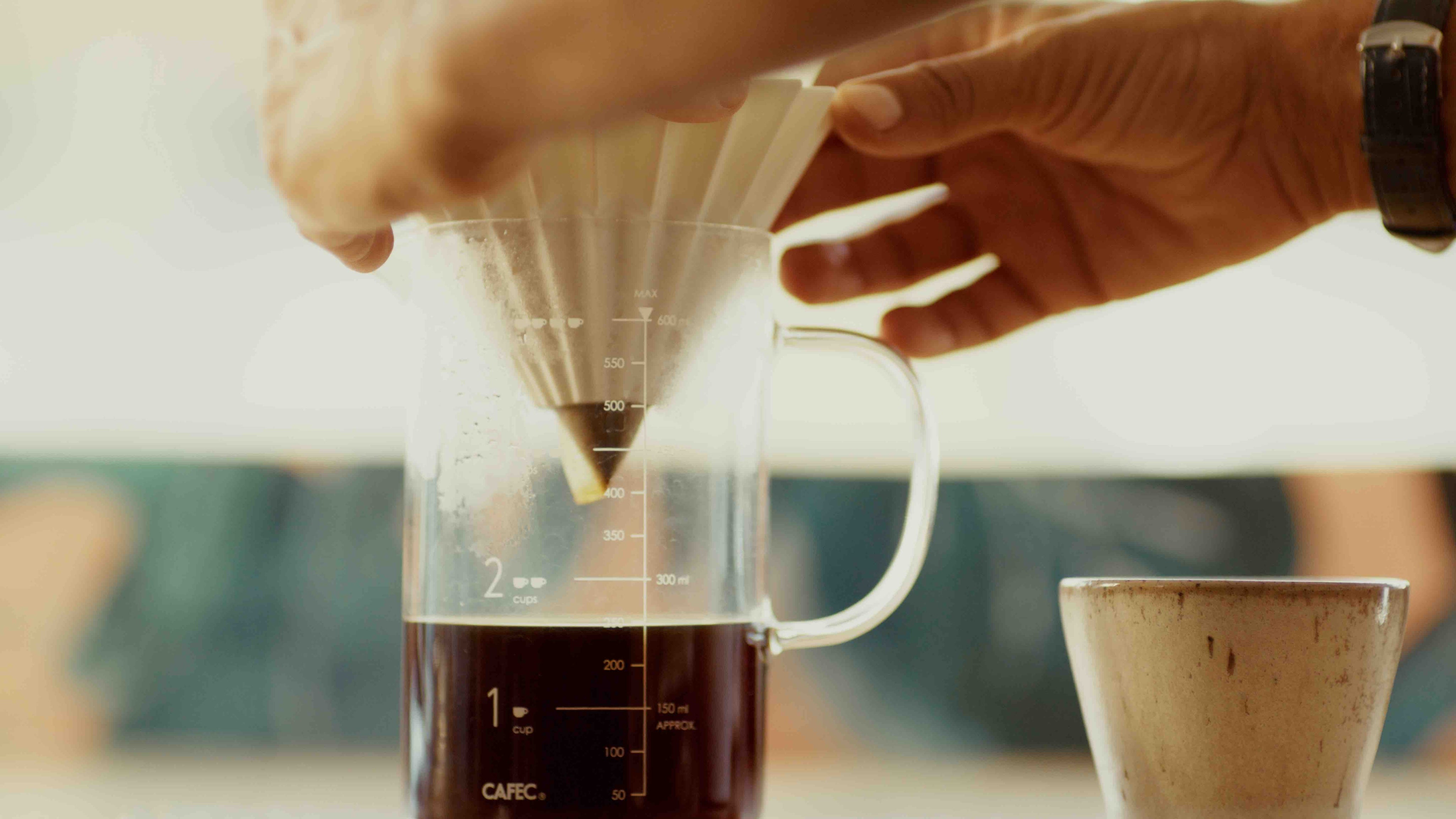 Pour-over coffee brewing with fresh grounds, representing Paradise Roasters single-origin coffees.