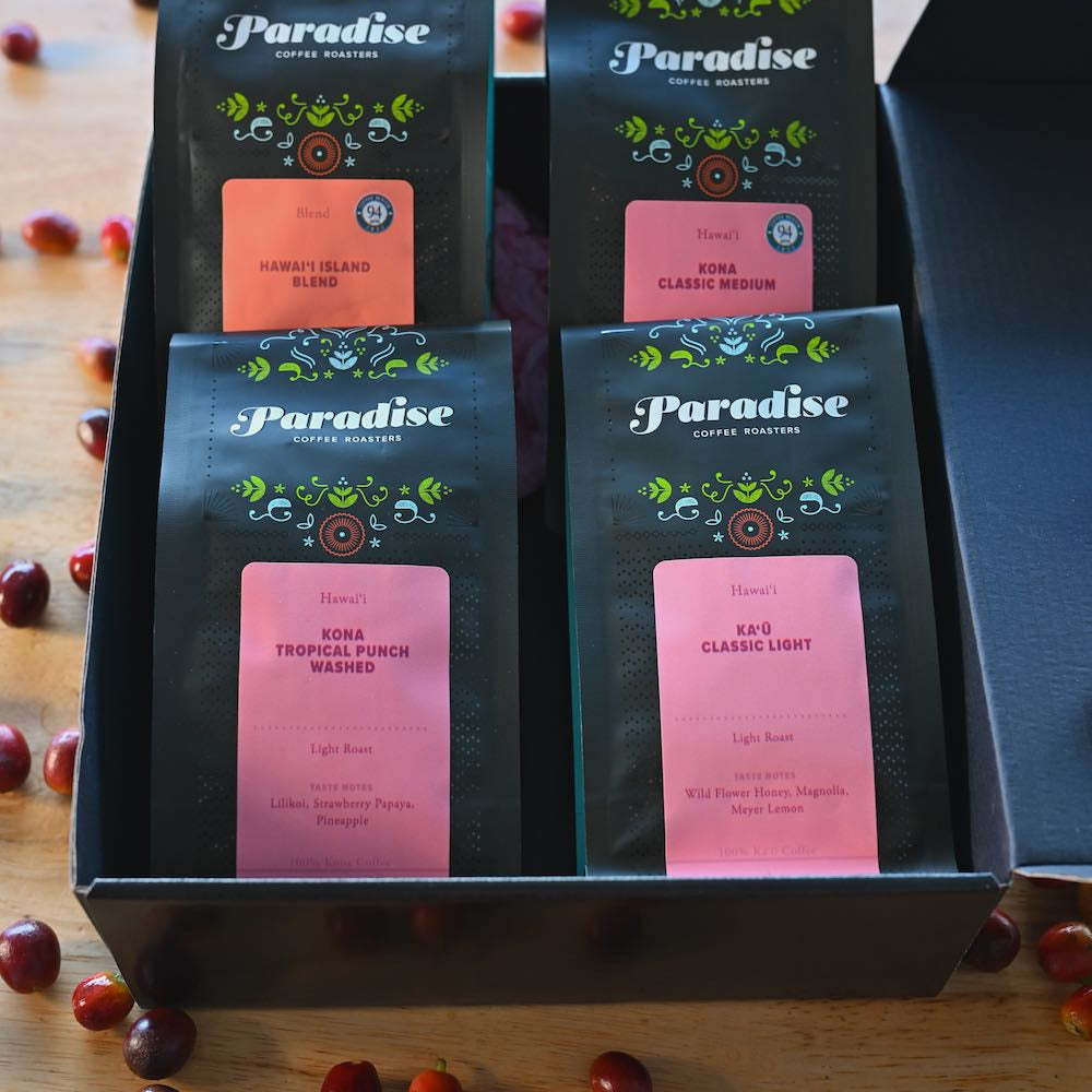 Hawai‘i coffee sampler box featuring Kona and Kaʻū coffees with cherries displayed around the gift box