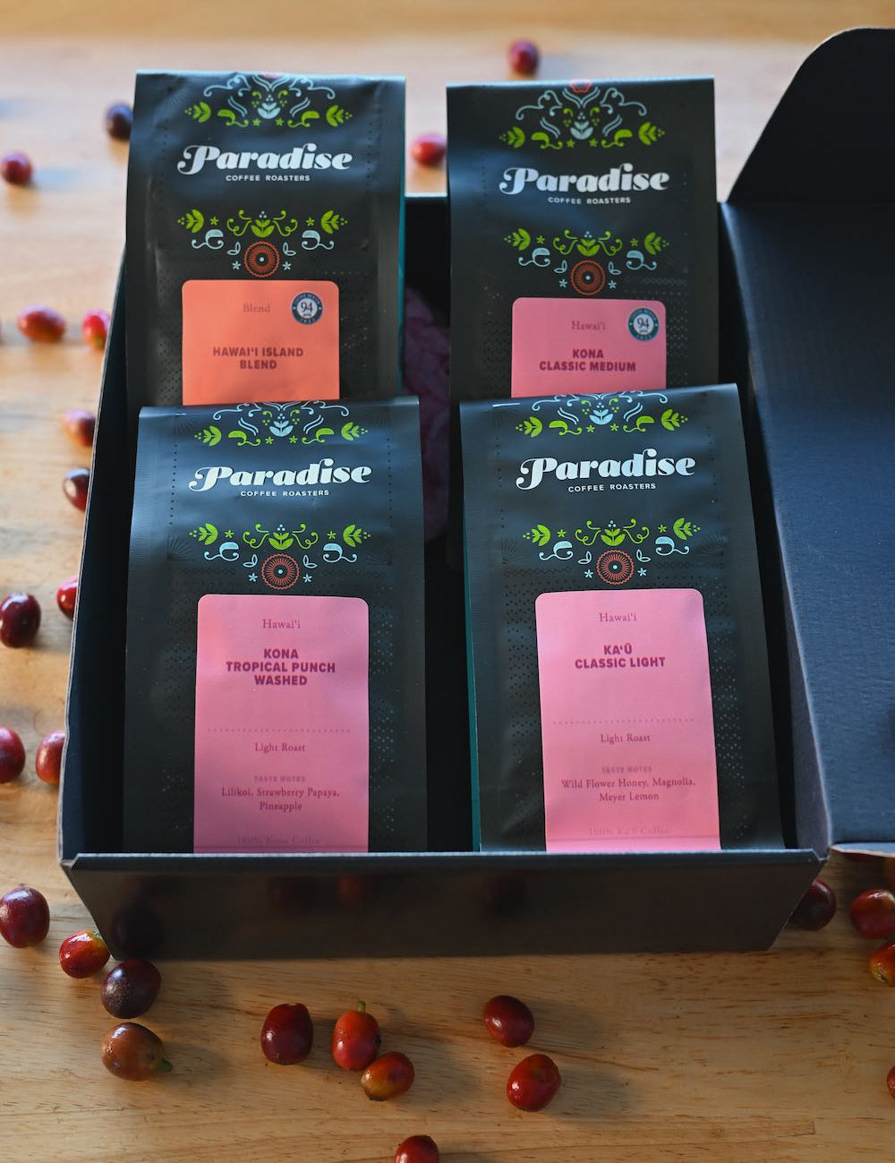 Hawai‘i coffee sampler box featuring Kona and Kaʻū coffees with cherries displayed around the gift box