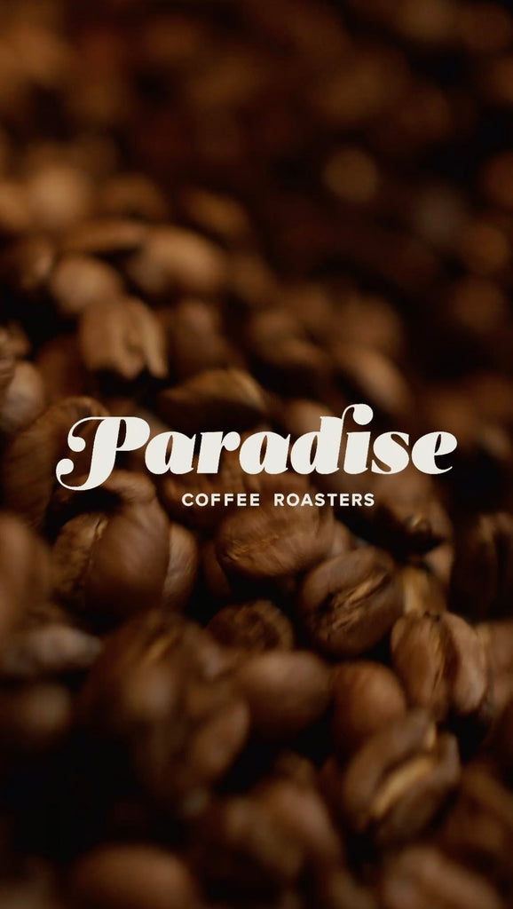 Kona Coffee medium roast beans in cooling tray at Paradise Coffee Roasters