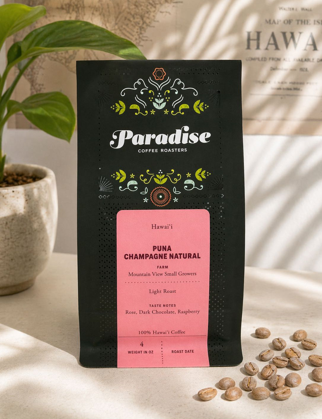 Paradise Coffee Roasters Puna Champagne Natural coffee bag with coffee beans on a light surface.